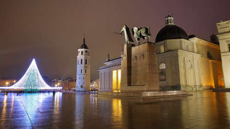 VILNIUS, LITHUANIA - JANUARY 1, 2017: Cathedral Square by night with from left to right: The illuminated Christmas tree, the Belfry (Cathedral Clock Tower) and the Cathedral - Gediminas Monument in the foregroundのeditorial素材