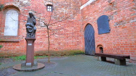 VILNIUS, LITHUANIA - JANUARY 2, 2017: A courtyard in the former small Jewish Ghetto with a statue of Metrastininkas (sculptor Vaclovas Krutinis)のeditorial素材