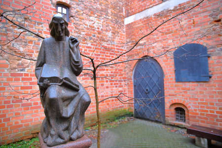 VILNIUS, LITHUANIA - JANUARY 2, 2017: A courtyard in the former small Jewish Ghetto with a statue of Metrastininkas (sculptor Vaclovas Krutinis)のeditorial素材