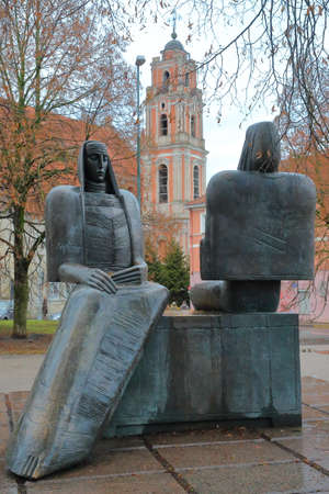 VILNIUS, LITHUANIA - JANUARY 2, 2017: Statues of Sofija Psibiliauskiene and Marija Lastauskiene on Karmelitu Street with the bell tower of All Saints Church in the backgroundのeditorial素材