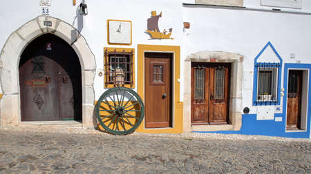 ESTREMOZ, PORTUGAL - OCTOBER 10, 2016: Colorful facade along a cobbled streetのeditorial素材