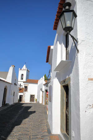 MONSARAZ, PORTUGAL - OCTOBER 11, 2016: A typical cobbled street with whitewashed housesのeditorial素材