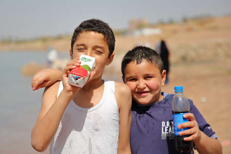 AQABA, JORDAN - MARCH 15, 2016: Portrait of two little boys smiling on a beachのeditorial素材