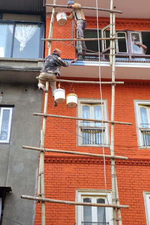 PATAN, NEPAL - DECEMBER 19, 2014: Wooden scaffolding with workers on dutyのeditorial素材
