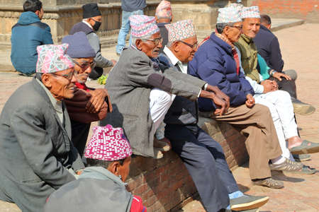 PATAN, NEPAL - DECEMBER 20, 2014: Nepalese men gathering and wearing Dhaka Topi (traditional Nepalese hat) at Durbar Squareのeditorial素材