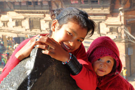 BHAKTAPUR, NEPAL - DECEMBER 30, 2014: Portrait of two cute little girls at Bhairabnath temple, Taumadhi Toleのeditorial素材