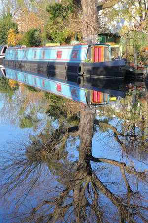 LONDON, UK: Reflections in Little Venice with colorful barges along canalsの写真素材