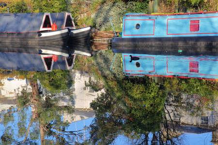 LONDON, UK: Reflections in Little Venice with colorful barges along canalsの写真素材