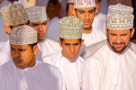 NIZWA, OMAN - FEBRUARY 3, 2012: Omani men traditionally dressed attending the Goat Marketのeditorial素材