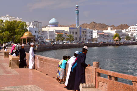 MUSCAT, OMAN - FEBRUARY 10, 2012: Muttrah corniche in Muscat with Omani young boys traditionally dressedのeditorial素材