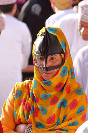 NIZWA, OMAN - FEBRUARY 3, 2012: Portrait of a bedouin Omani woman traditionally dressed attending the Goat Market in Nizwaのeditorial素材