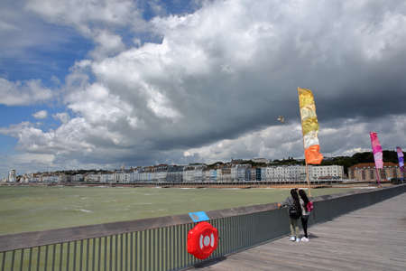 HASTINGS, UK - JULY 23, 2017: View of the seafront from the Pier (rebuilt and open to public in 2016) with a beautiful cloudy skyのeditorial素材