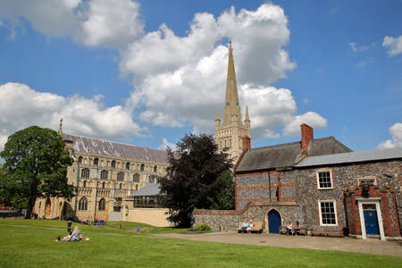 NORWICH, UK - JUNE 3, 2017: View of the Cathedral with people enjoying a sunny day- view from the gardensのeditorial素材