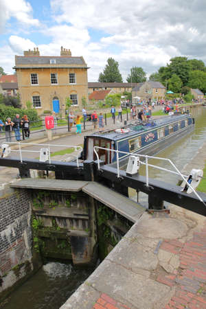 Bradford on Avon, UK - AUGUST 13, 2017: People enjoying a summer day at Canal Wharf with colorful barges on Kennet and Avon Canalのeditorial素材