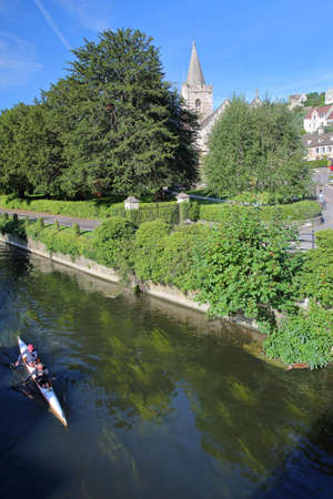 Bradford on Avon, UK - AUGUST 13, 2017: Rowing on the river Avon with Holy Trinity Church in the backgroundのeditorial素材