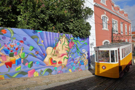 LISBON, PORTUGAL - NOVEMBER 4, 2017: Elevador da Gloria, the  funicular connecting the Restauradores Square to Bairro Alto neighborhood with Street Art on the wallsのeditorial素材