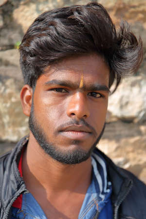 CHITTORGARH, RAJASTHAN, INDIA - DECEMBER 13, 2017: Portrait of a young man  inside the fort (Garh)...