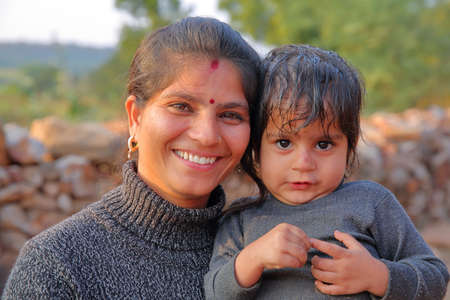 CHITTORGARH, RAJASTHAN, INDIA - DECEMBER 13, 2017: Portrait of a beautiful smiling woman with her little boyのeditorial素材