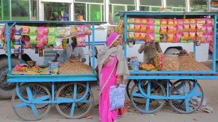 NAWALGARH, RAJASTHAN, INDIA - DECEMBER 26, 2017: Colorful street scene at the bus station in the old town with food stallsのeditorial素材