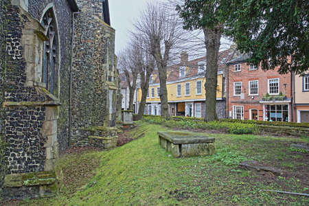 Elm Hill cobbled street with medieval houses from the Tudor period with St Simon and St Jude Chuch on the left in Norwich, Norfolk, UKの写真素材