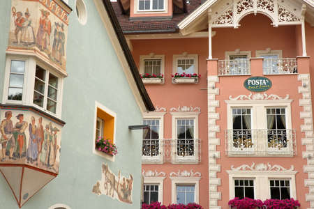 VAL GARDENA, ITALY - JUNE 28, 2018: Colorful house facades (decorated with art paintings) in the...