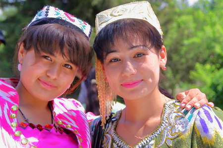 BUKHARA, UZBEKISTAN - MAY 11, 2011: Two young Uzbek women traditionally dressed posing inside the Bakhautdin Naqshband mausoleum near Bukharaのeditorial素材