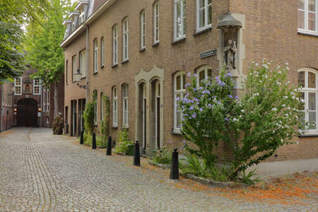MAASTRICHT, NETHERLANDS - AUGUST 03, 2019: De Bosquetplein, a cobbled street leading to the entrance of Natural History Museum, with typical 17th century housesのeditorial素材