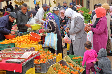 TOZEUR, TUNISIA - DECEMBER 21, 2019: The lively and colorful fruit and vegetable market with locals