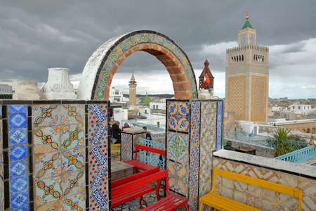 TUNIS, TUNISIA - DECEMBER 29 2019: Colorful tiled terrace overlooking the medina, with a view on the...