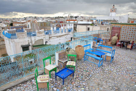 TUNIS, TUNISIA - DECEMBER 29 2019: Colorful tiled terraces overlooking the medina, with a panoramic...