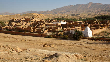 The ruins of the abandoned village of Tamerza near Nefta, Tunisia, with a desert landscapeの写真素材