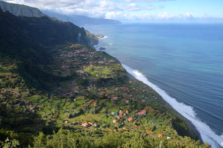 The spectacular North coast from Sao Jorge (and Arco de Sao Jorge) to Ponta Delgada viewed from the viewpoint Miradouro da Beira da Quinta, Madeira island, Portugalの写真素材