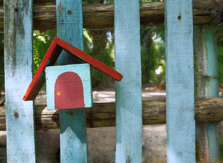 little home red roof home decoration stuff hang on wood fenceの写真素材