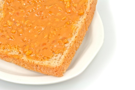 Bread slice and peanut butter isolated on white backgroundの写真素材