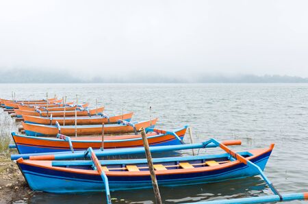 boats and lot of foggy on a lakeの写真素材