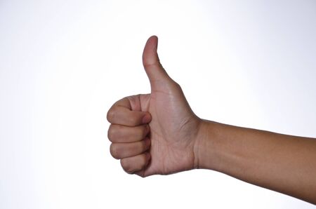 Closeup of male hand showing thumb up sign on white backgroundの写真素材