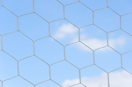 Soccer goal net in soccer stadium and blue sky.の写真素材