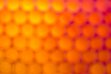 Blurred bright orange bubbles as background.の写真素材
