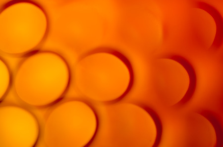 Blurred bright orange bubbles as background.の写真素材