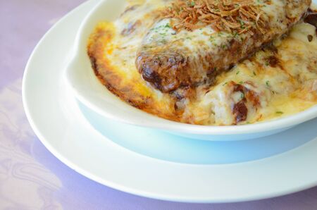 Omelette rice with grilled pork on white plateの写真素材