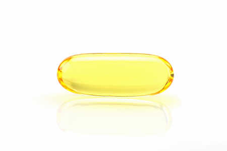 Close up golden color fish oil supplement in soft gel capsule, healthy product.の写真素材