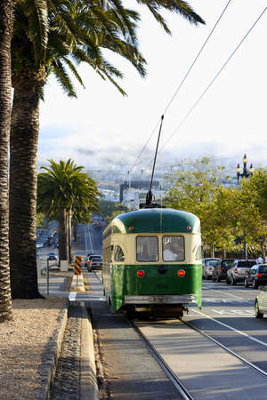 MUNI San Francisco Streetcar on a steep hill with the Twin Peaks in the backgroundのeditorial素材