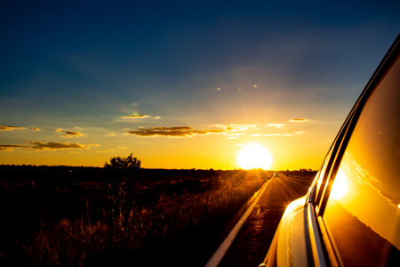 Sunset in desert in carの写真素材