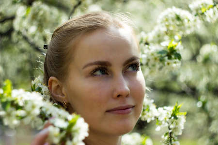 Beautiful spring girl in blooming tree