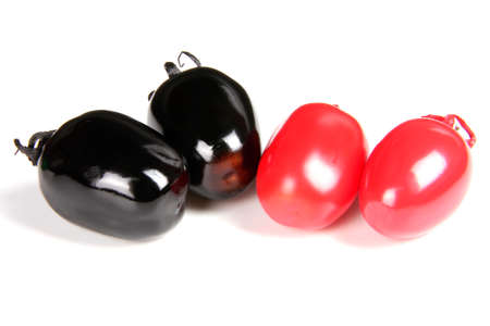 cherry tomatoes painted in different color isolated on white backgroundの写真素材