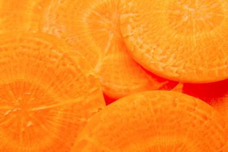 background full of many fresh carrot slices