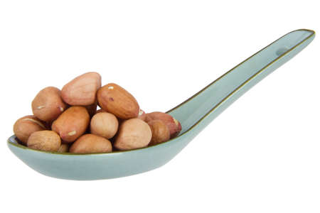 close up of peanut with china scoop isolated on white backgroundの写真素材