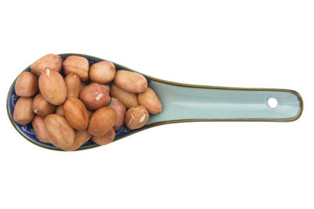 close up of peanut with china scoop isolated on white backgroundの写真素材