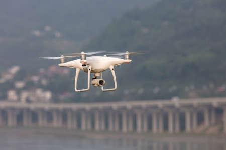 The View of a White Aerial Photographic UAV In the Air.の写真素材