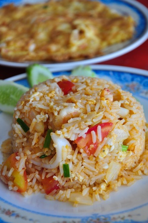 Yummy seafood fried rice served with thai-style shrimp omeletteの写真素材